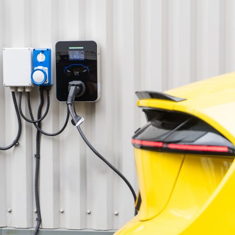 Wall Mounted Smart EV Charger plugged into Lotus Electric Car