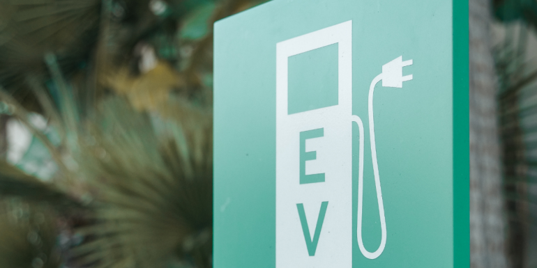a sign with a picture of an EV Charger